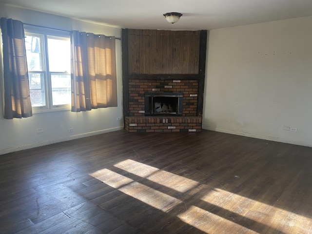 unfurnished living room with dark hardwood / wood-style floors and a fireplace