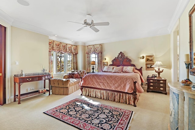 carpeted bedroom with ornamental molding and ceiling fan