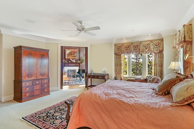 bedroom featuring ornamental molding, a wood stove, light colored carpet, and ceiling fan