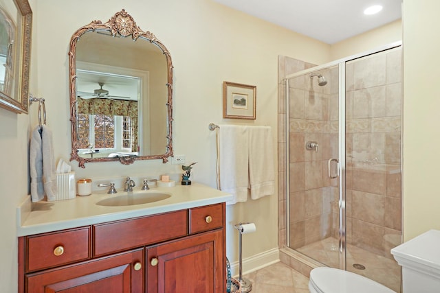 bathroom with tile patterned floors, toilet, a shower with door, and vanity