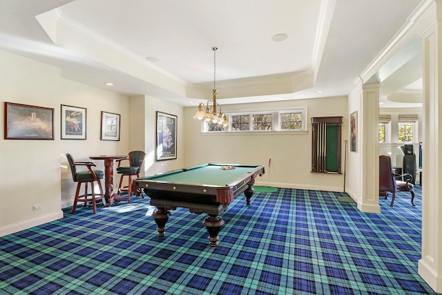 game room with ornamental molding, a wealth of natural light, a raised ceiling, and dark colored carpet