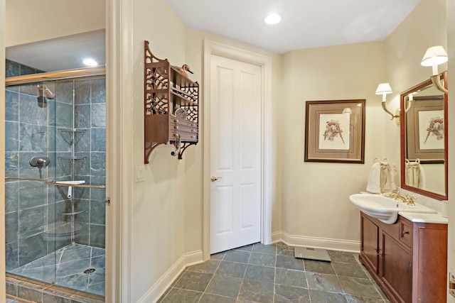 bathroom with vanity and a shower with shower door