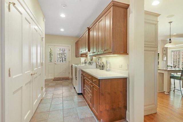 kitchen featuring independent washer and dryer and decorative light fixtures