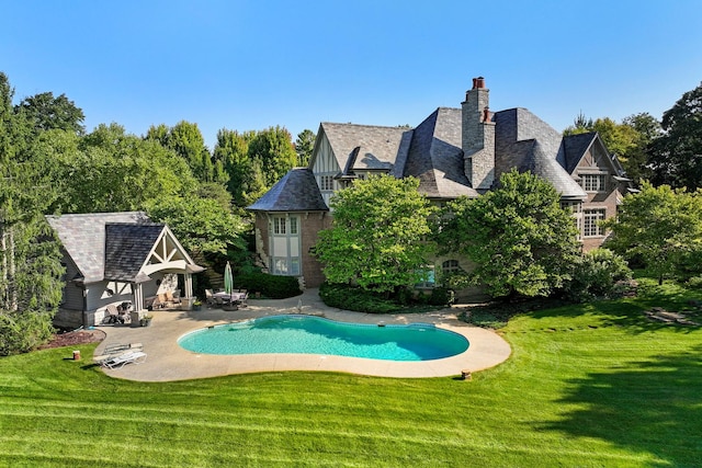 view of swimming pool with a yard and a patio area