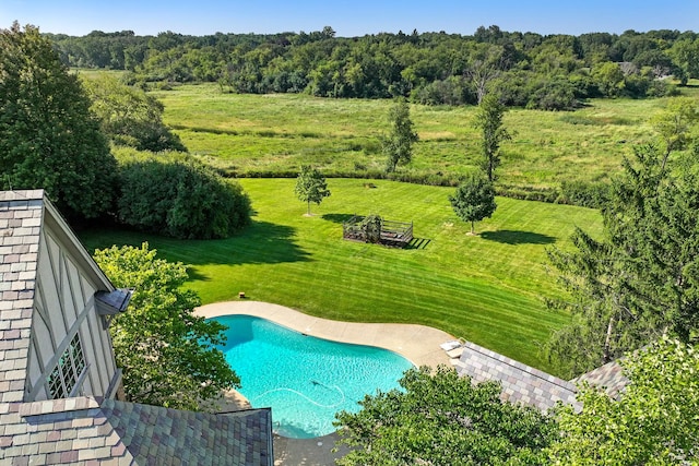 view of pool featuring a lawn