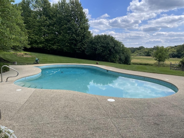 view of pool with a yard and a patio area