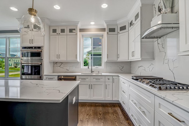 kitchen featuring pendant lighting, white cabinetry, sink, exhaust hood, and stainless steel appliances