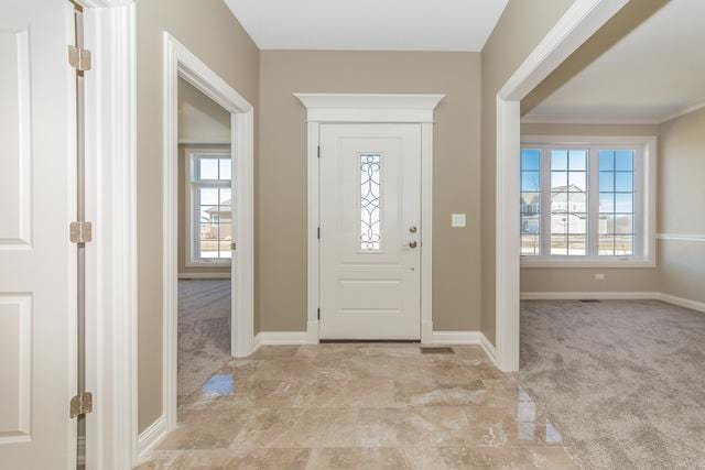 view of carpeted entrance foyer