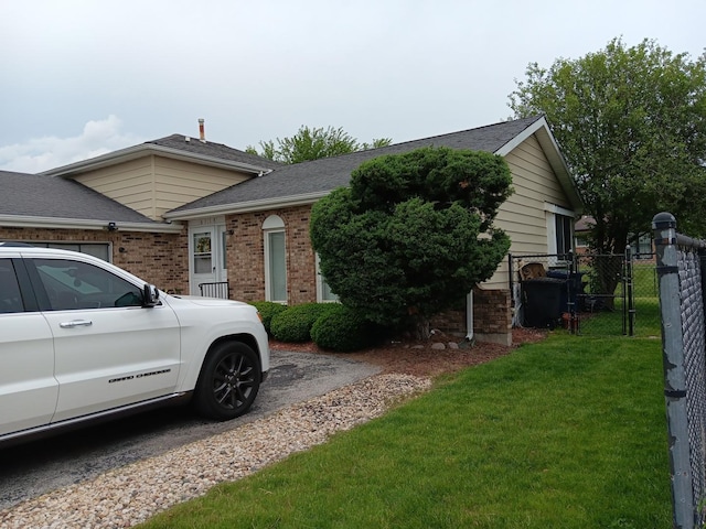 view of side of property with a yard