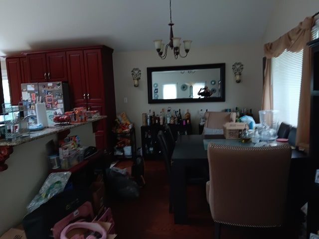 dining area featuring a healthy amount of sunlight and a notable chandelier