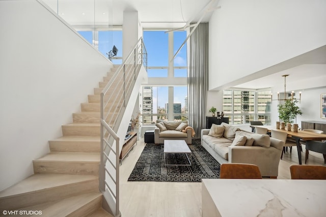 living room with a chandelier and light hardwood / wood-style flooring