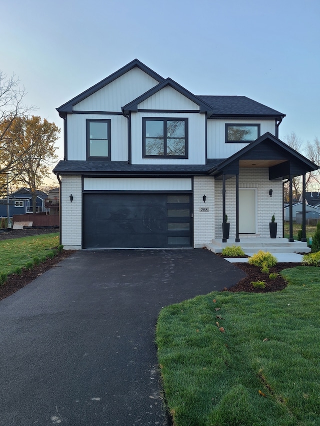 view of front facade with a garage and a front yard