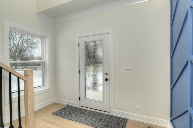 bathroom featuring hardwood / wood-style floors, ornamental molding, and sink