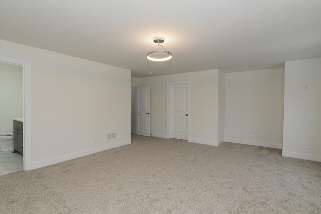 carpeted spare room featuring a healthy amount of sunlight