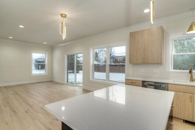 kitchen featuring hanging light fixtures, a kitchen island, ornamental molding, light hardwood / wood-style floors, and stainless steel appliances