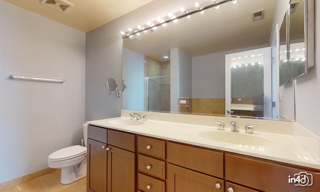 bathroom with tile patterned flooring, vanity, toilet, and an enclosed shower