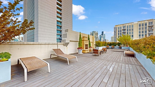 wooden terrace with an outdoor living space