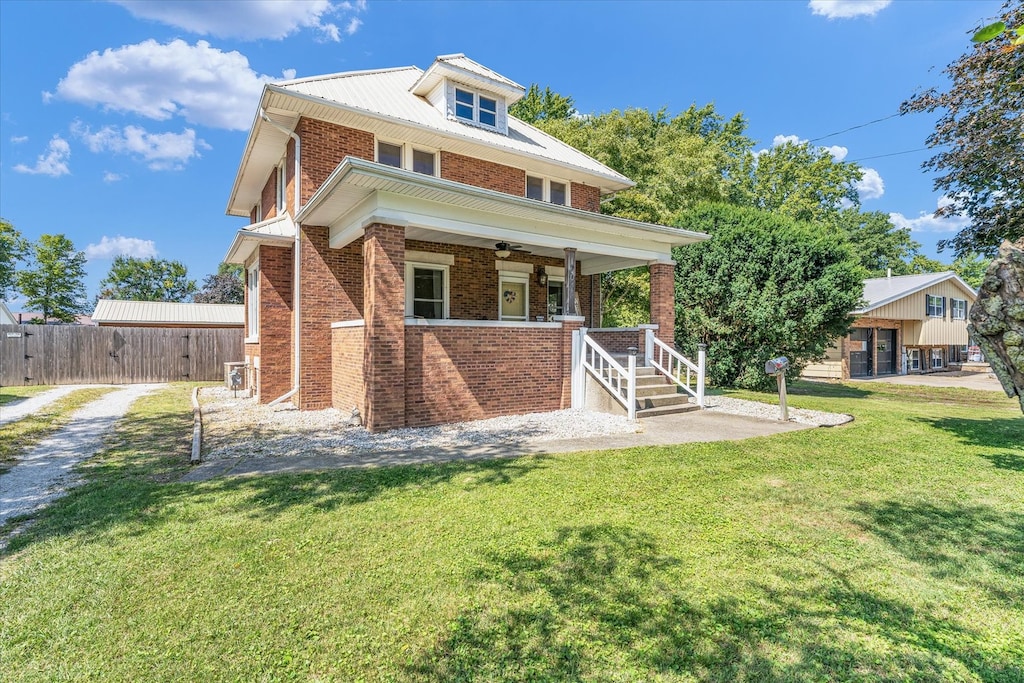 rear view of property with a yard and ceiling fan