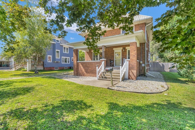 view of front of home featuring a front lawn and covered porch