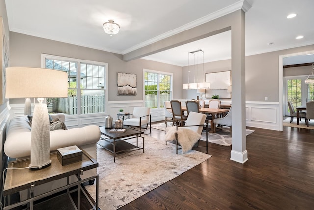 living room with wood-type flooring and ornamental molding