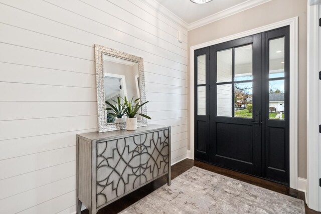 foyer with ornamental molding and wood-type flooring