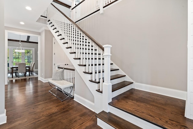 staircase with hardwood / wood-style floors and crown molding