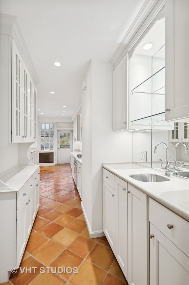 kitchen featuring sink, white cabinets, and light tile patterned floors