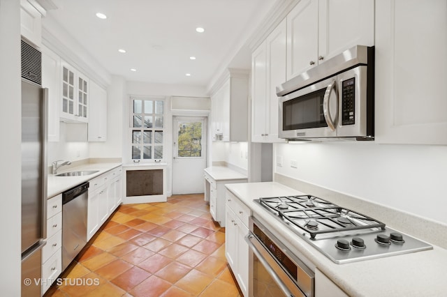 kitchen featuring light tile patterned flooring, sink, white cabinetry, and stainless steel appliances