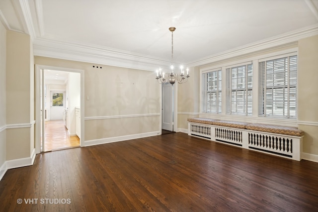 unfurnished dining area featuring ornamental molding, dark wood-type flooring, and a notable chandelier