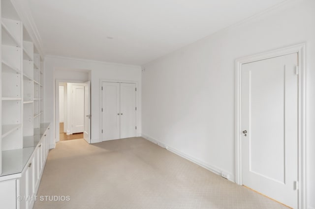 unfurnished bedroom featuring light carpet