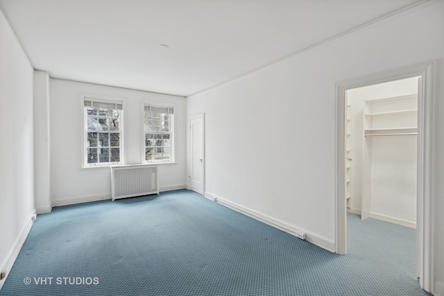 carpeted empty room featuring radiator