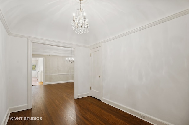 unfurnished room featuring ornamental molding, dark hardwood / wood-style flooring, and a notable chandelier