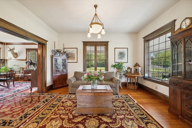 living room with light hardwood / wood-style flooring and an inviting chandelier