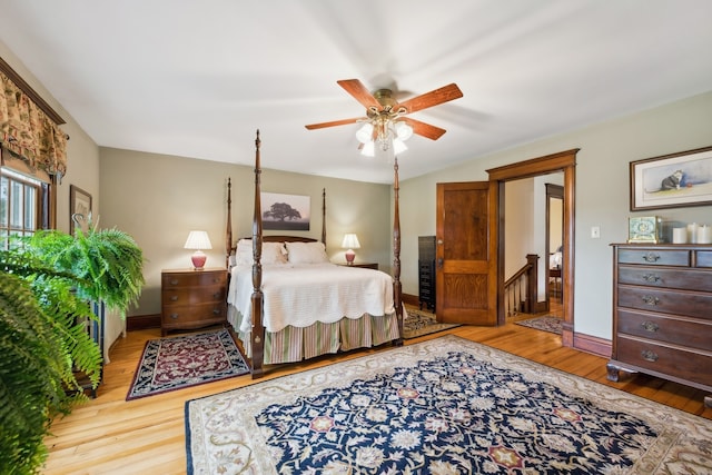 bedroom with ceiling fan and hardwood / wood-style floors