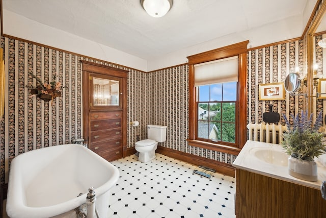 bathroom with a tub, radiator, tile patterned floors, toilet, and vanity