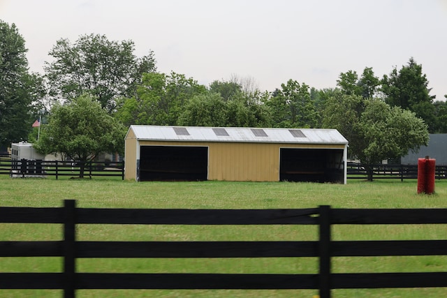 exterior space featuring an outbuilding and a lawn