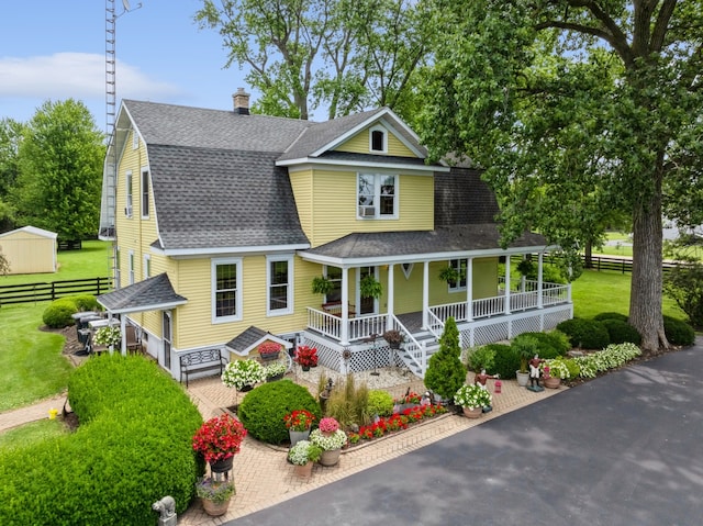 view of front facade with covered porch and a front lawn