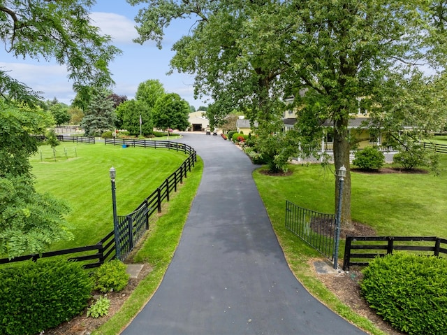 view of property's community with a lawn and a rural view