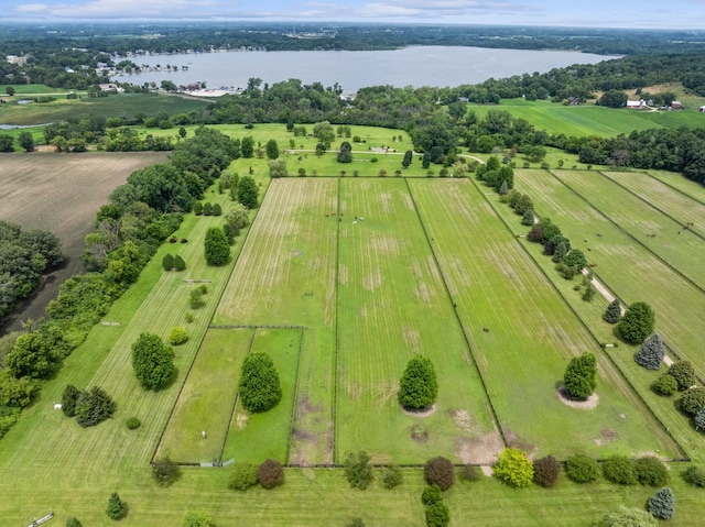 birds eye view of property featuring a water view and a rural view