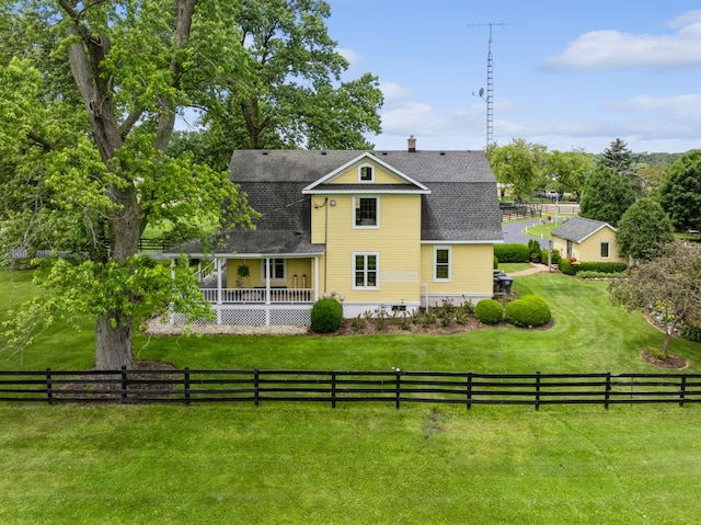 rear view of house with a yard