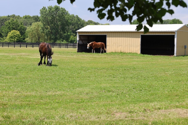 view of yard with an outbuilding and a rural view