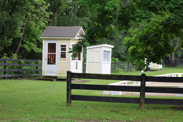 exterior space featuring a lawn and a shed