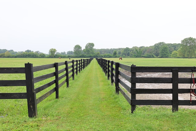 view of gate featuring a rural view and a yard