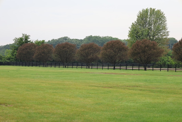 view of home's community featuring a lawn and a rural view