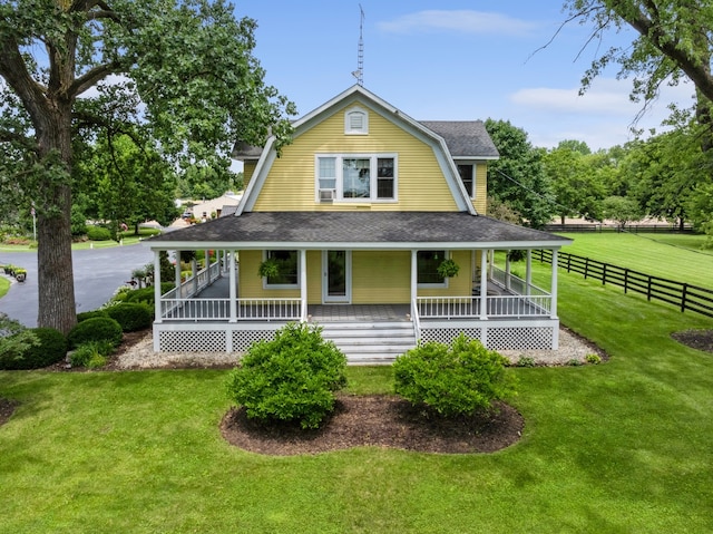 back of house featuring a porch and a lawn