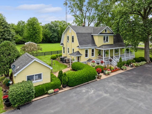 view of front of house with a porch and a front lawn