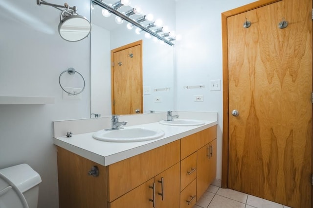 bathroom with tile patterned floors, vanity, and toilet