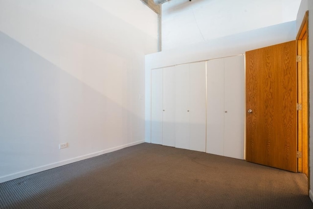 unfurnished bedroom featuring carpet flooring and a closet