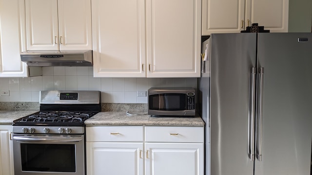 kitchen with white cabinetry, decorative backsplash, and stainless steel appliances