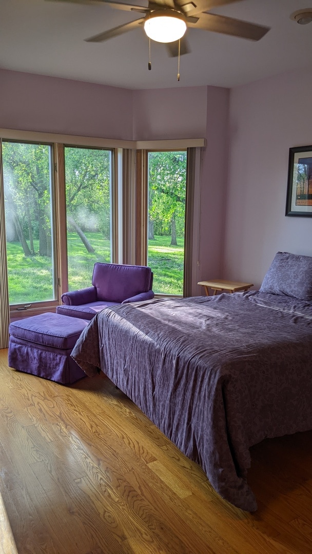 bedroom with ceiling fan and light wood-type flooring